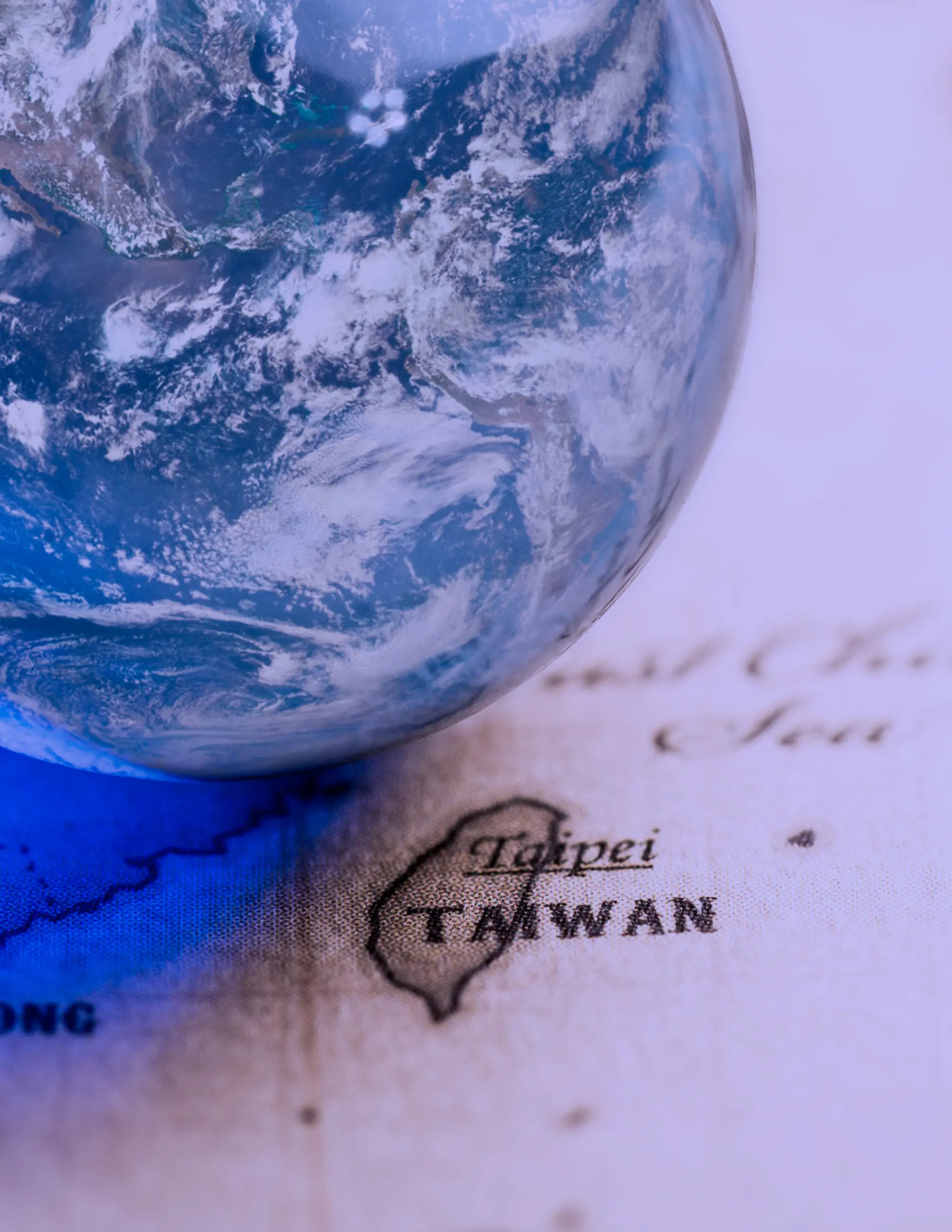 Image of a globe next to Taiwan on a map.