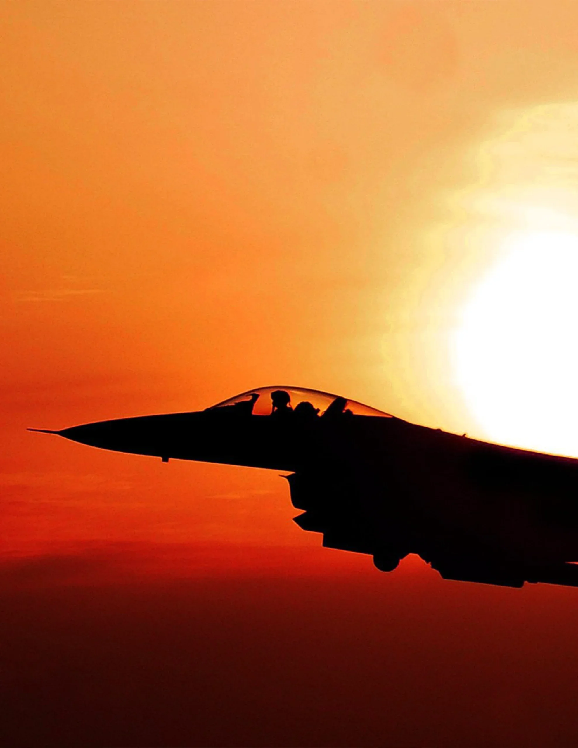 Image of a jet with a sunset in the background